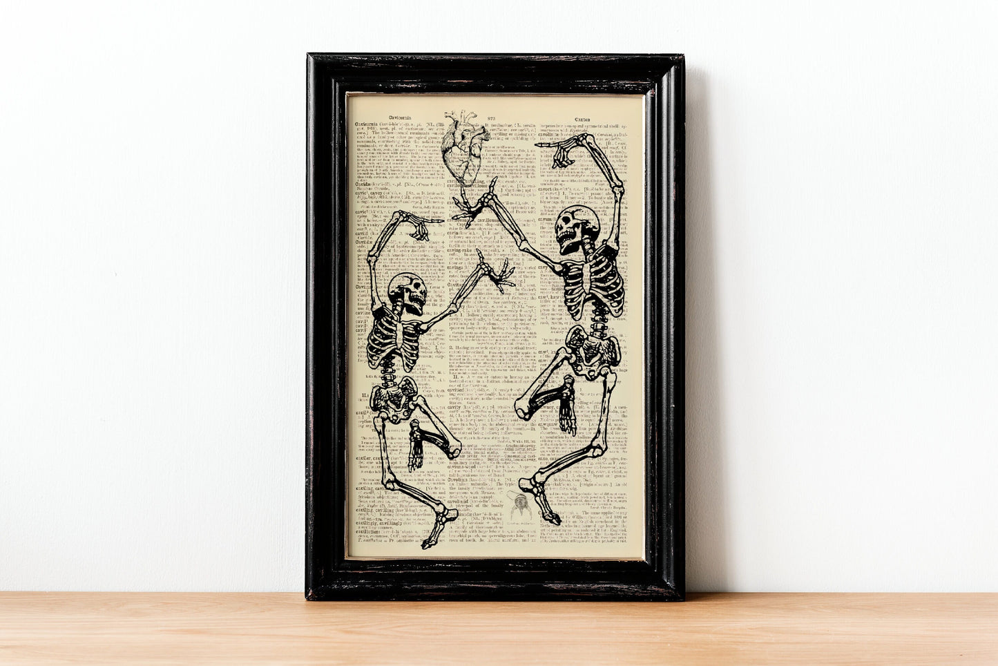 Two Skeletons Dancing Printed On An Antique Old Dictionary Page